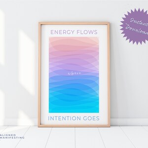 Puede incluir: Una impresión enmarcada con un fondo degradado de rosa, azul y turquesa. El texto "ENERGY FLOWS where INTENTION GOES" está impreso en la impresión.