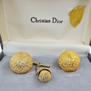 Elegant vintage Christian Dior cufflinks and tie tack set in textured gold tone, presented in the original