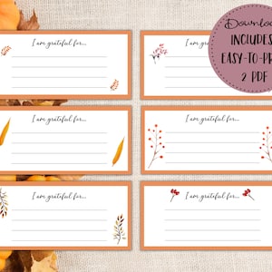 May include: Six printable cards with an orange background and a white border. Each card has a line drawing of fall foliage and the text "I am grateful for..." printed on it.
