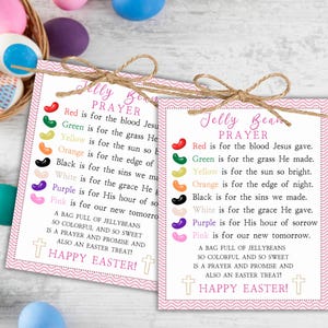 May include: Two pink cards with a "Jelly Bean Prayer" printed on them, tied with twine. The cards have a pink border and include a list of jelly bean colors and their meanings, with "Happy Easter!" at the bottom.