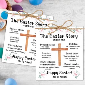 May include: A printable Easter story snack mix activity. The printable features a cross, a white jellybean, a pretzel stick, a goldfish cracker, a round cracker, and a sweet treat. The text includes the Easter story and scripture verses. Happy Easter! He is risen!