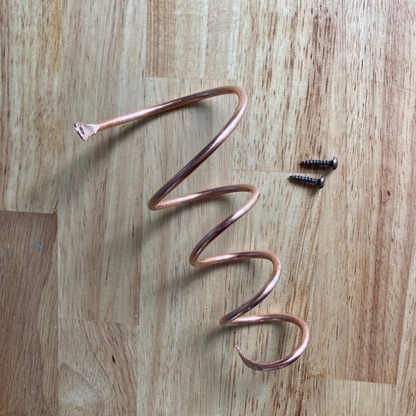 Wine bottle holder, coiled copper, wall mounted