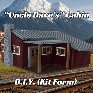 May include: A red wooden cabin model kit with a gray roof and a porch. The kit is labeled "Uncle Dave's Cabin" and "D.I.Y. (Kit Form)".