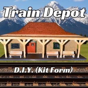 May include: A model train depot kit in the form of a small, brown building with a red roof and a wooden porch. The building has two windows and a door. The kit is sitting on a model railroad track. The text "Train Depot" is above the building and "D.I.Y. (Kit Form)" is below the building.