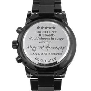 May include: Black wristwatch with a silver engraved message on the back. The message reads "Excellent Husband Would choose in every lifetime! Happy 53rd Anniversary! I love you forever Love, Holly".