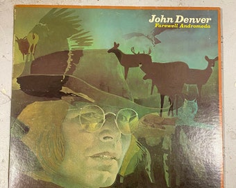 May include: A vintage vinyl record album cover featuring a portrait of John Denver with a green and brown background. The album title is "Farewell Andromeda" and the artist's name is "John Denver".