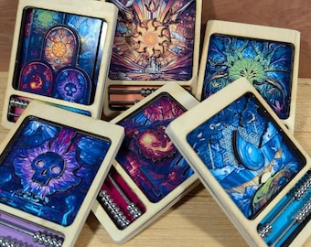 May include: Six wooden boxes with colorful, abstract designs and abacus-like features. Each box has a different image, including a skull, a sun, and a tree.