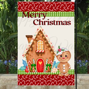 May include: A Christmas garden flag featuring a gingerbread house and gingerbread man. The flag has a red and white candy cane border, green and white checkered stripe, and the words "Merry Christmas" in red. The gingerbread house has a red door with a heart.