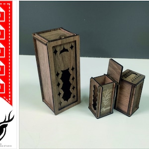 May include: Wooden boxes with intricate cut-out designs. The largest box has a hinged lid and a decorative pattern. Two smaller boxes are also visible, one with a hinged lid and the word "Oregano" etched on the side. The boxes are made of a dark wood.