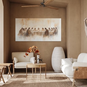 The Last Supper wall art is a large Christian canvas print hanging in a minimalist living room above the couch in neutral tones. This modern Christian art shows Jesus having His Last Supper with His twelve disciples. This Last Supper Painting is a Christian print or Catholic art and is a long horizontal wall art. Religious artwork, Last Supper print, Christian wall art, Jesus Wall Art, Above Bed Art, Last Supper Art, Last Supper Art Print, Jesus Painting, Jesus Art