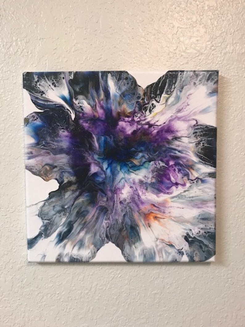 May include: Abstract painting on canvas with swirling colors of white, black, purple, blue, and orange. The colors create a flower-like shape in the center of the canvas.