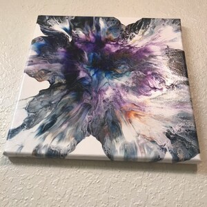 May include: Abstract painting on canvas with a white background and a large, colorful, purple, blue, and black flower-like design.