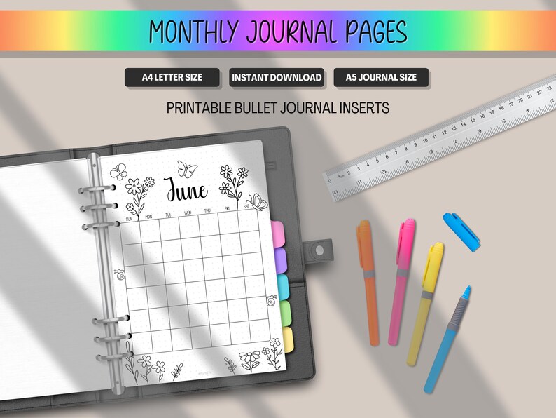 May include: A black journal open to a June monthly calendar page with floral and butterfly illustrations. The page is surrounded by colorful pens, a ruler, and the text "MONTHLY JOURNAL PAGES". The journal is A4 and A5 size.