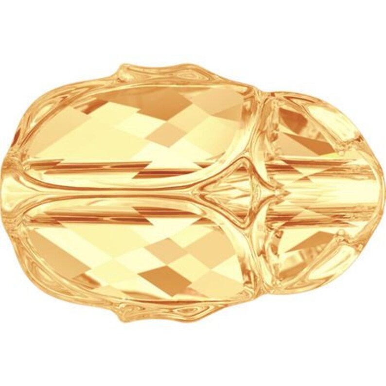 May include: A gold-colored faceted glass bead with a unique, intricate design. The bead has a rounded shape and a smooth, polished surface.
