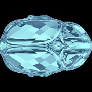 May include: A light blue crystal bead with a faceted design. The bead has a rounded shape and is made of glass.