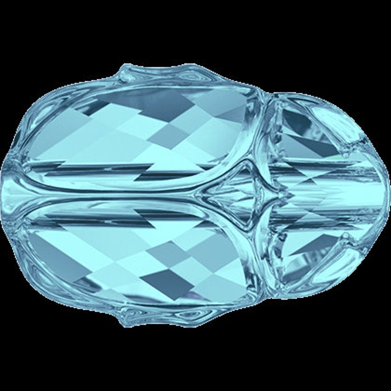 May include: A light blue crystal bead with a faceted design. The bead has a rounded shape and is made of glass.