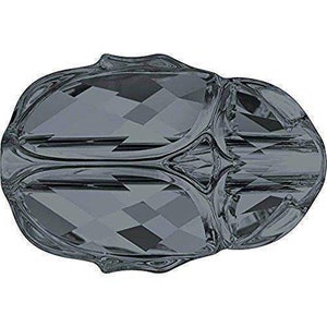 May include: A dark gray faceted glass bead with a geometric design. The bead has a rounded shape and a smooth, shiny surface.