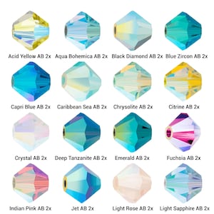 Könnte beinhalten: Sechzehn facettierte Kristallperlen in verschiedenen Farben, darunter Acid Yellow, Aqua Bohemica und Capri Blue. Jede Perle hat ein metallisches Loch zum Auffädeln. Der Text auf dem Bild identifiziert jede Farbe.