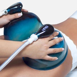 May include: A person using a blue and white suction cup device for a body treatment. The device has the word "SKIN" printed on it.