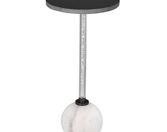 May include: A modern side table with a black circular top and a clear, bubble-filled stem. The base is a white marble sphere. The table is designed for indoor use and has a contemporary aesthetic.