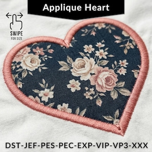 May include: Embroidered applique heart with a floral pattern in pink and cream on a navy blue background. The heart is outlined with a pink stitch. Text at the top reads "Applique Heart".