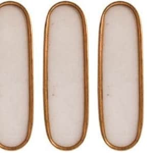 May include: Six elongated, oval-shaped decorative elements. Each has a white, opaque center framed by a thin, copper-colored metal border. The objects are arranged in a horizontal row, showcasing their uniform design and finish.