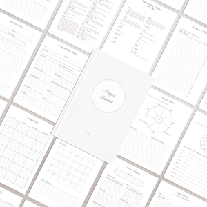 May include: A white prayer journal with a circular emblem on the cover, surrounded by various open pages featuring printed templates for sermon notes, Bible reading trackers, scripture logs, prayer wheels, thought logs, and habit trackers.