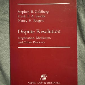 May include: A maroon textbook titled Dispute Resolution: Negotiation, Mediation, and Other Processes by Stephen B. Goldberg, Frank E. A. Sander, and Nancy H. Rogers, published by Aspen Law & Business, featuring white text on a solid maroon cover.