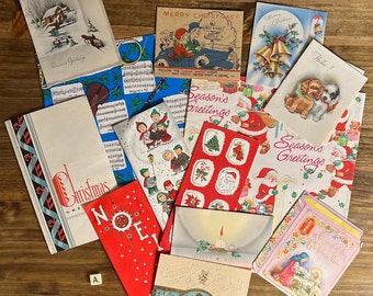 May include: A collection of vintage Christmas cards and wrapping paper featuring various holiday themes, including a car, a snowman, a bell, a dog, and a Santa Claus. The cards are decorated with red, green, and white colors and feature festive illustrations.