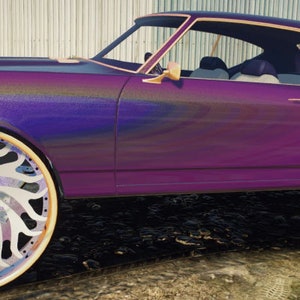 May include: A purple Chevrolet Chevelle with large, custom, multi-colored wheels. The car has a gold trim around the windows and a gold stripe along the side.
