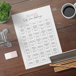 May include: A printable 30-day self-care challenge checklist with daily activities to promote well-being. The checklist is printed on white paper and includes activities such as starting a gratitude journal, learning to meditate, taking a walk outdoors, listening to a podcast, and reading inspirational quotes.