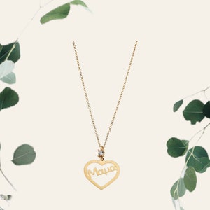 May include: A gold necklace with a heart-shaped pendant that says "Mama" with a small diamond in the center.