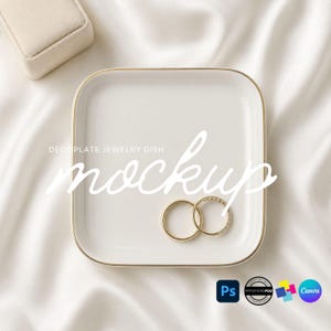 May include: A square white jewelry dish with a gold-toned rim, featuring two gold rings placed in the center. The dish is overlaid with the text DECOPLATE JEWELRY DISH mockup. A small beige box is visible in the upper left corner of the frame.