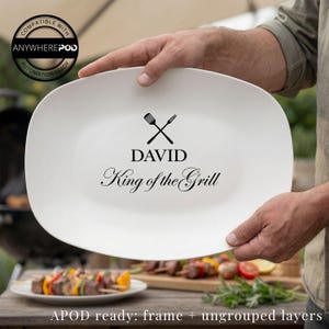May include: A white oval platter with the text "DAVID King of the Grill" and crossed grill tools. The platter is held by a person. The image also includes the text "COMPATIBLE WITH ANYWHEREPOD AUTOMATION READY" and "APOD ready: frame + ungrouped layers".