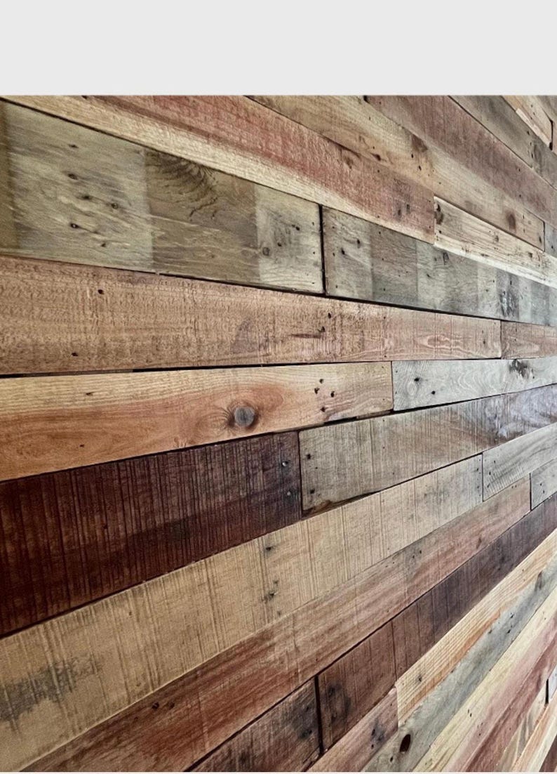 May include: A wall made of reclaimed wood planks in various shades of brown, gray, and red. The planks are arranged in a horizontal pattern, creating a rustic and industrial look.