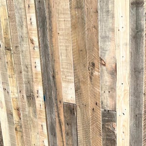 May include: A wall made of reclaimed wood planks, featuring a variety of wood tones and textures. The planks are arranged in a vertical pattern, creating a rustic and natural look.