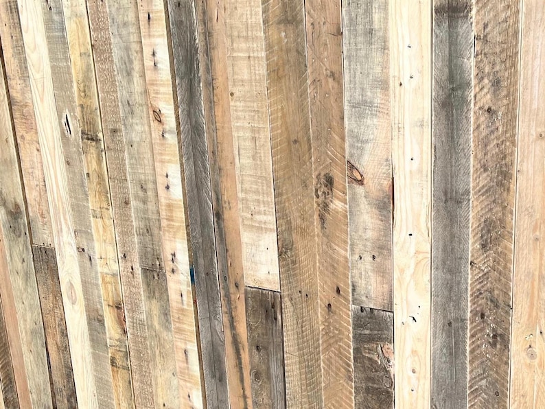 May include: A wall made of reclaimed wood planks, featuring a variety of wood tones and textures. The planks are arranged in a vertical pattern, creating a rustic and natural look.