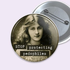 May include: Two round pinback buttons. One button features a sepia-toned portrait of a woman with long, wavy hair. The text "STOP protecting pedophiles" is printed on the button. The second button is silver.