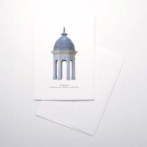 Könnte beinhalten: Eine weiße und blaue Illustration einer Kuppel, ein kleines kuppelförmiges Bauwerk, mit dem Text "CUPOLA GREENEVILLE, NORTH CAROLINA" darunter.