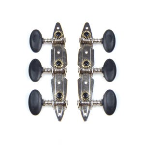 May include: Two sets of three guitar tuning pegs arranged in vertical strips. Each tuner features a silver-colored metal base plate, a small brass-colored gear, a black plastic oval-shaped tuning knob, and a black screw securing the gear mechanism.
