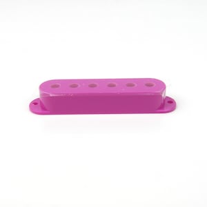 May include: A purple plastic guitar pickup cover with six holes.