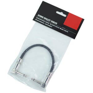 May include: A black instrument cable with silver connectors, packaged in a clear plastic bag. The black label reads "STUDIO QUALITY CABLES" with options for microphone, audio, and MIDI cables, and guitar/bass/instrument.