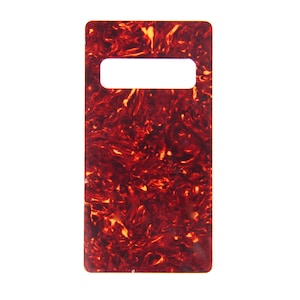 May include: A red and brown tortoiseshell guitar pickguard with a rectangular shape and a cutout for a pickup.