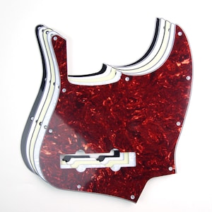 May include: A set of four red, white, and black bass guitar pickguards. The pickguards are made of a tortoiseshell-like material and have a cutout for the pickup.