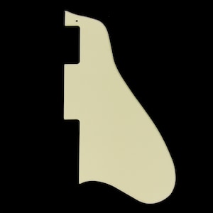 May include: A cream-colored guitar pickguard with a rounded shape and a small hole at the top.
