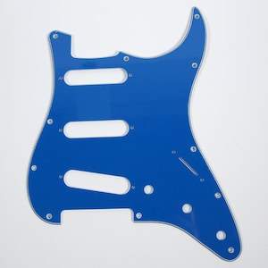 May include: A blue electric guitar pickguard with cutouts for pickups and controls.