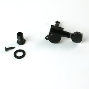 May include: Black guitar tuning pegs with a screw, washer, and a black plastic bushing.