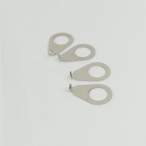 May include: Four silver metal guitar strap buttons with a small hole in the centre of each button.