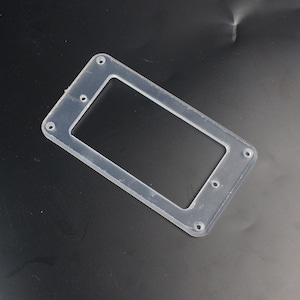 May include: A clear plastic guitar pickup ring with four screw holes.