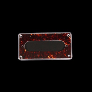 May include: A tortoiseshell guitar pickup cover with a black pickup cavity and four screw holes.